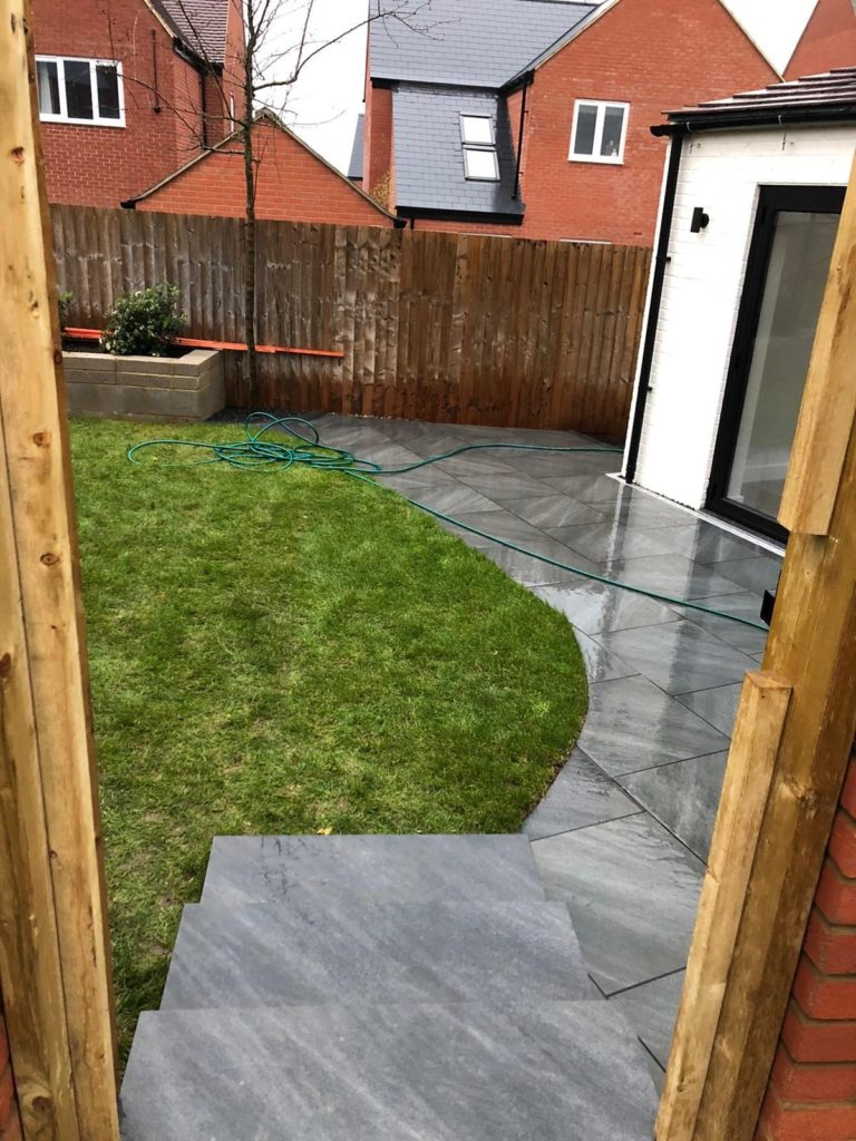 New turf laid up to the newly finished porcelain patio