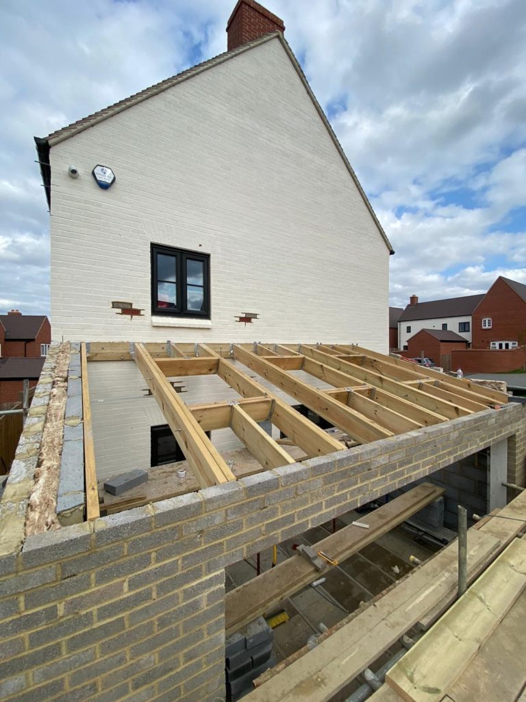 Building extension roof with space for electrically operated Velux's